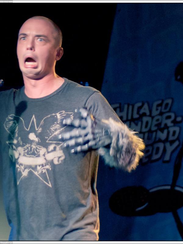 Stand-up comedian on stage under a single spotlight