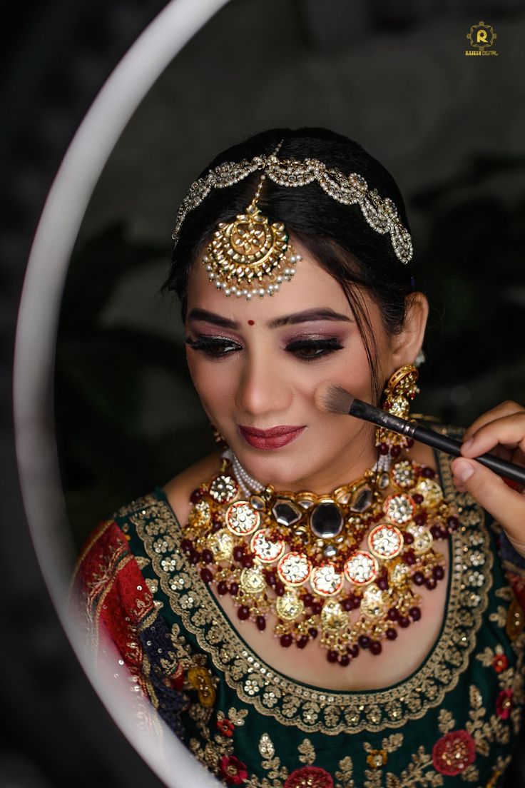 Bride having her makeup finished by an artist before the ceremony
