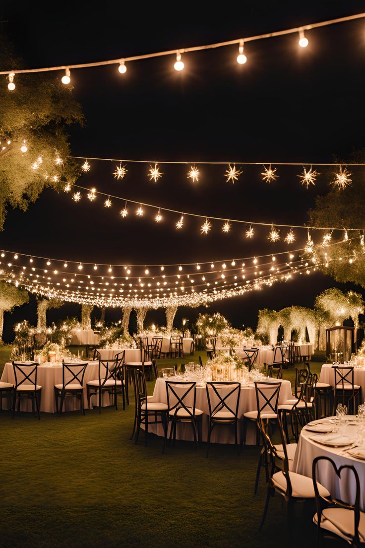 Banquet hall set for a wedding reception with round tables and warm uplighting